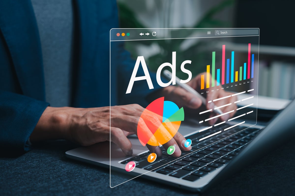 Marketer reviewing a digital advertising dashboard with campaign performance charts